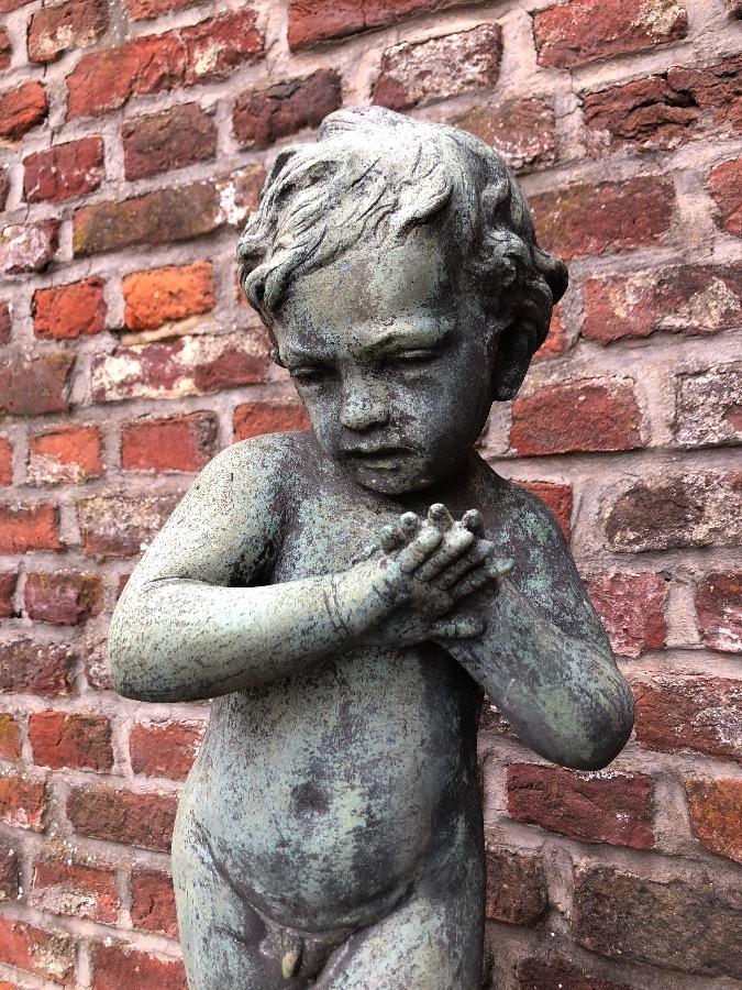 Old fountain with bronz putti on concrete base.